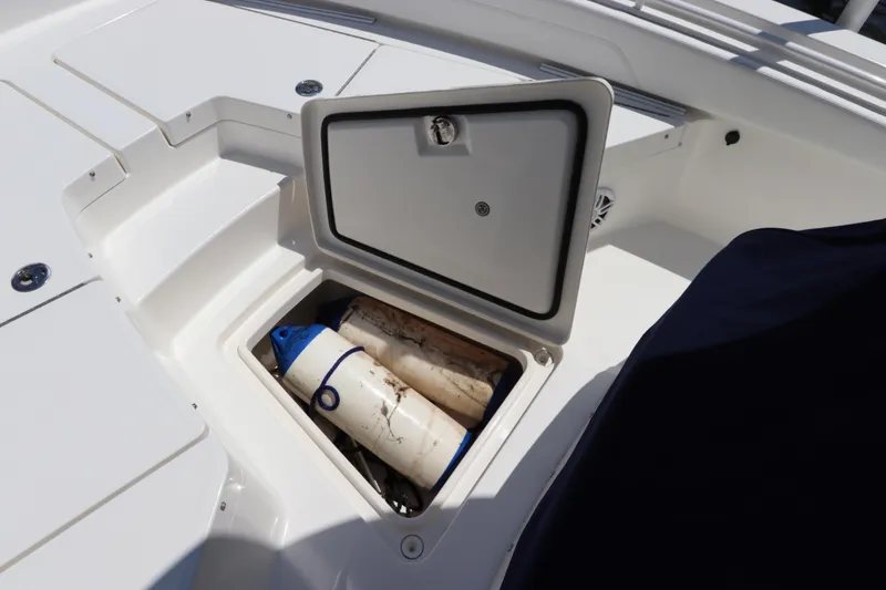 Slide: The Image of Open storage compartment on 2021 Regulator 24XO boat with fenders inside. - 32
