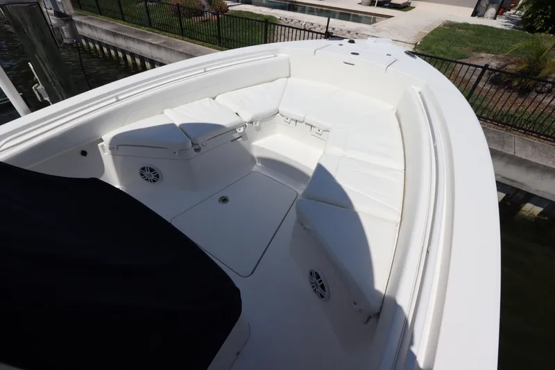 Slide: The Image of 2021 Regulator 24XO boat interior with white cushioned seating and speakers. - 34