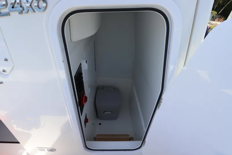 Slide: The Image of 2021 Regulator 24XO boat storage compartment with open door, showcasing interior space. - 39