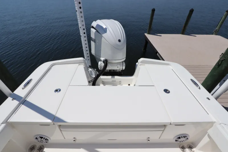 Slide: The Image of 2021 Regulator 24XO boat stern with Yamaha outboard motor at dock. - 7