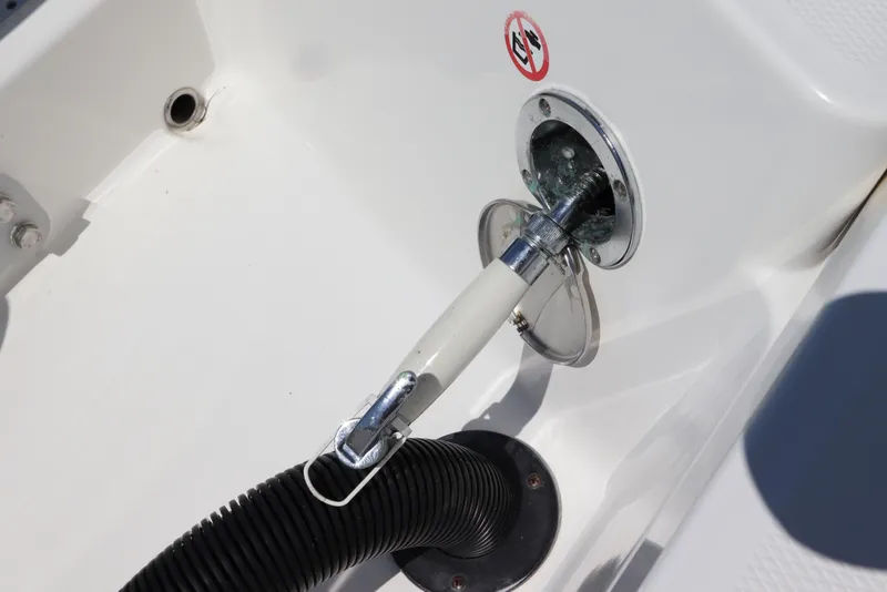 Slide: The Image of Fuel port on a 2021 Regulator 24XO boat with a connected hose. - 8
