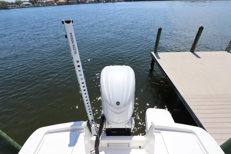 Slide: The Image of 2021 Regulator 24XO boat with Minn Kota motor near a dock. - 9