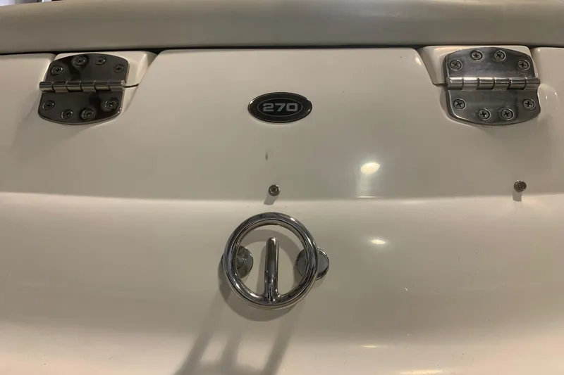 Slide: The Image of Close-up of a 2007 Bryant 270 boat's rear with chrome fittings and hinges. - 10