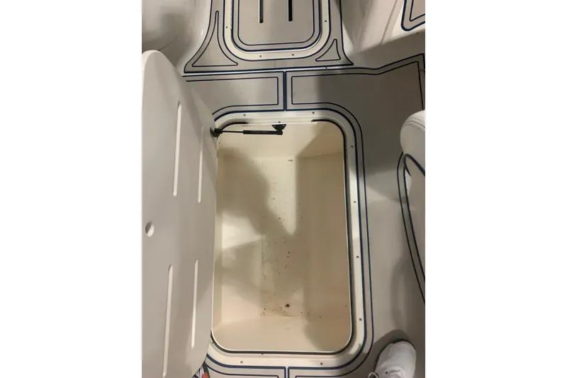 Slide: The Image of Open storage compartment on a 2007 Bryant 270 boat with patterned flooring. - 15
