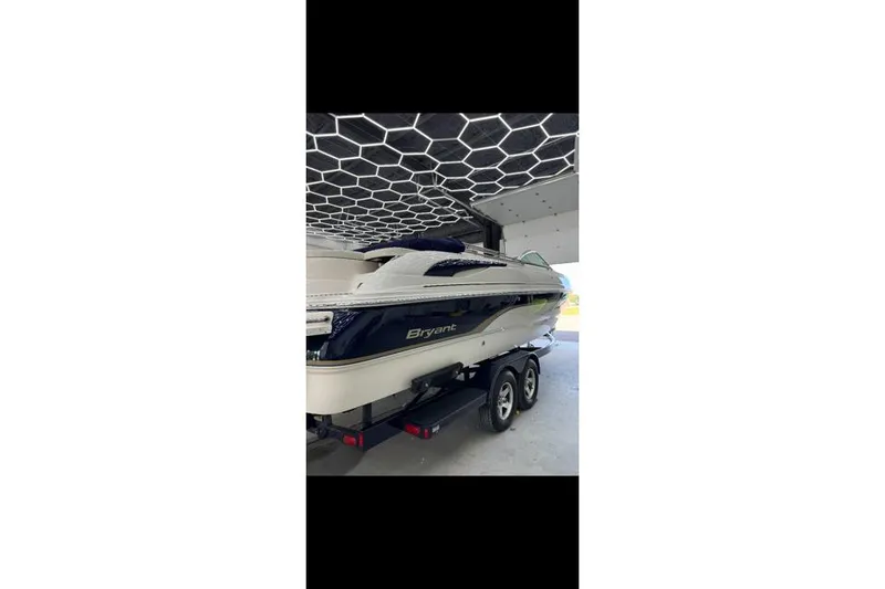 Slide: The Image of 2007 Bryant 270 boat on trailer in garage with hexagonal ceiling design. - 22