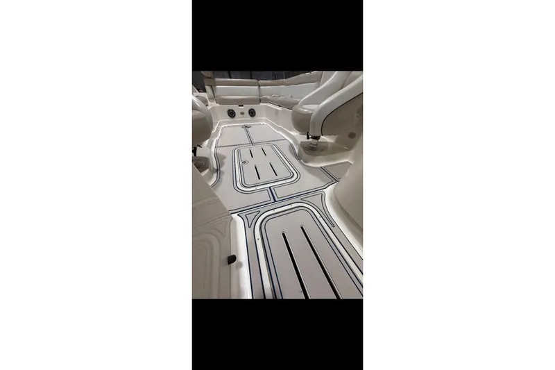 Slide: The Image of Interior view of a 2007 Bryant 270 boat with sleek seating and flooring design. - 25