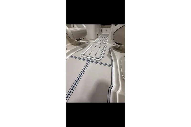 Slide: The Image of Interior view of a 2007 Bryant 270 boat, showcasing sleek flooring design. - 26