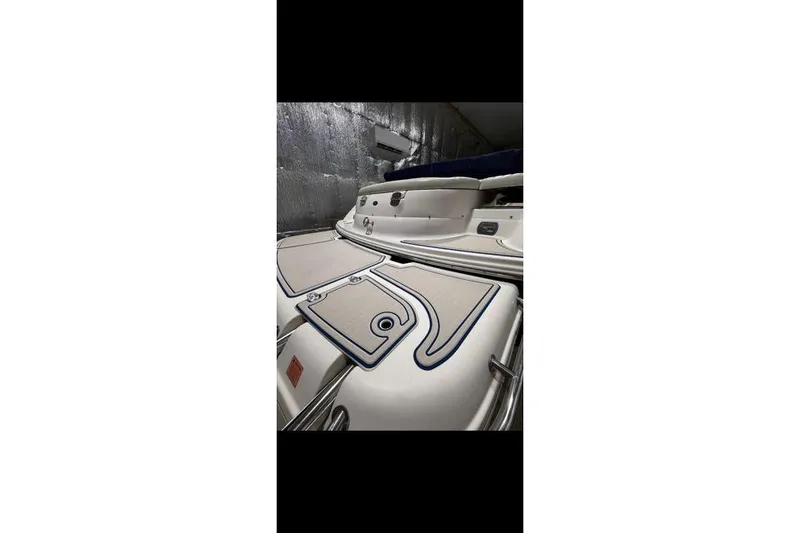 Slide: The Image of 2007 Bryant 270 boat interior with cushioned seating and storage compartments. - 28