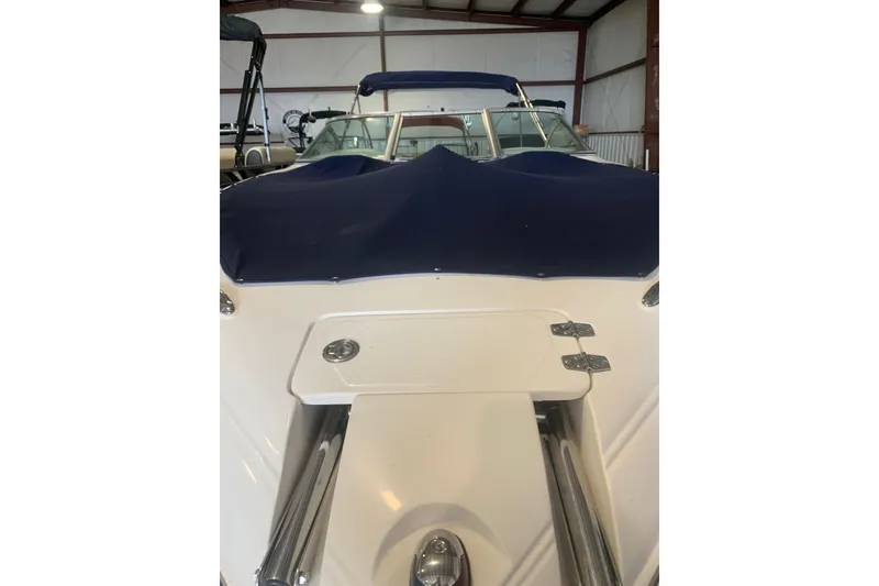 Slide: The Image of 2007 Bryant 270 boat with blue cover in storage facility. - 3