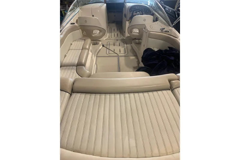 Slide: The Image of Interior of a 2007 Bryant 270 boat with beige seating and steering console. - 5