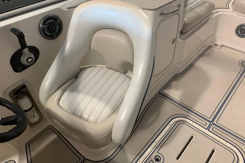 Slide: The Image of 2007 Bryant 270 boat interior with white captain's seat and steering wheel. - 7