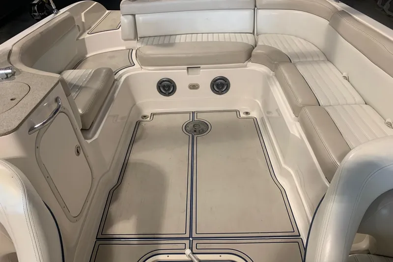 Slide: The Image of 2007 Bryant 270 boat interior with beige seating and storage compartments. - 9