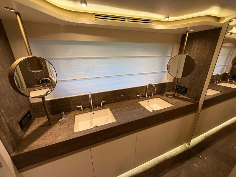 Slide: The Image of Luxurious bathroom on 2026 Azimut Magellano 25M yacht with dual sinks and elegant lighting. - 25