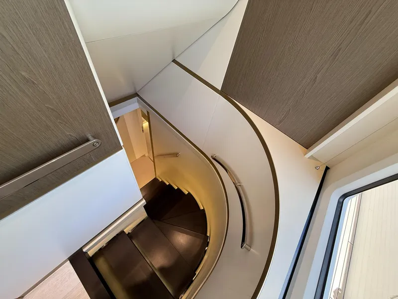 Slide: The Image of Interior staircase of 2026 Azimut Magellano 25M yacht, featuring modern design and wood accents. - 29