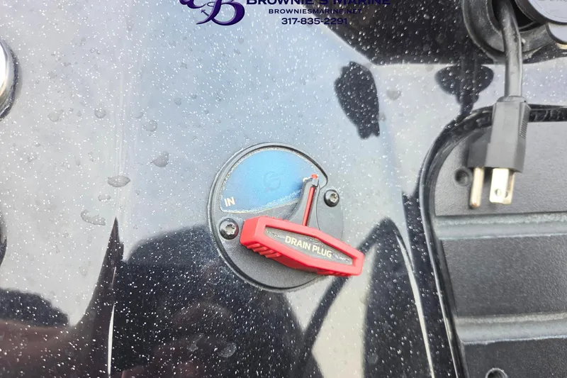 Slide: The Image of 2023 Ranger Z520R boat drain plug with water droplets and power cord. - 18