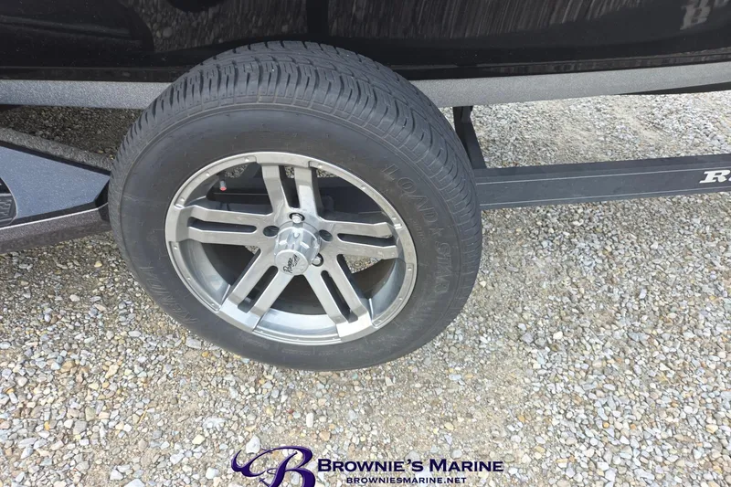 Slide: The Image of 2023 Ranger Z520R trailer wheel on gravel surface, featuring alloy rim design. - 25