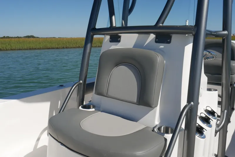 Slide: The Image of 2023 Sea Born FX24 Bay boat interior with cushioned seating and cup holders. - 14