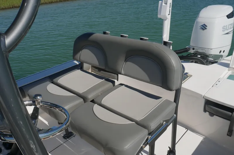 Slide: The Image of 2023 Sea Born FX24 Bay boat interior with seating and Suzuki outboard motor. - 18
