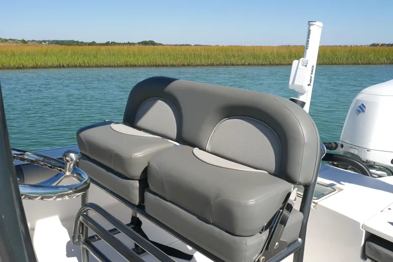 Slide: The Image of 2023 Sea Born FX24 Bay boat with comfortable seating, on a serene waterway. - 19