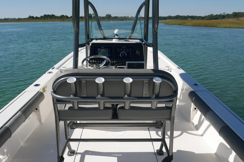 Slide: The Image of 2023 Sea Born FX24 Bay boat interior with steering console on calm water. - 20