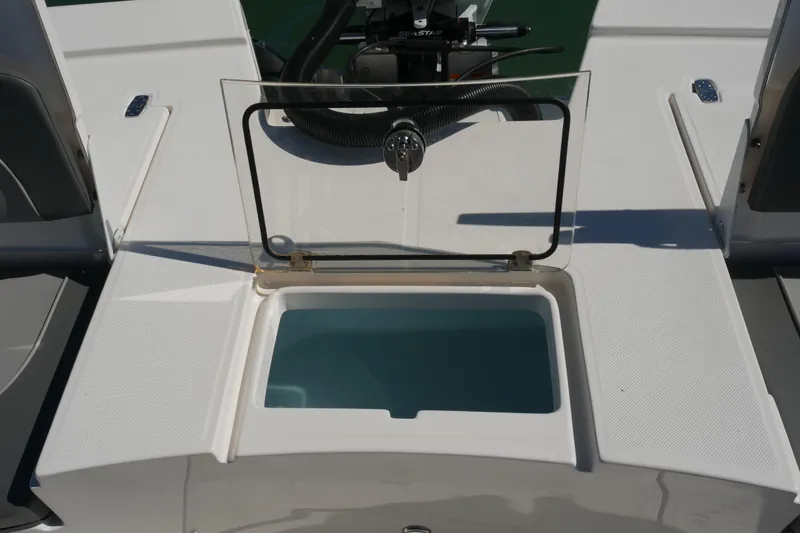 Slide: The Image of 2023 Sea Born FX24 Bay boat with open storage compartment on deck. - 25