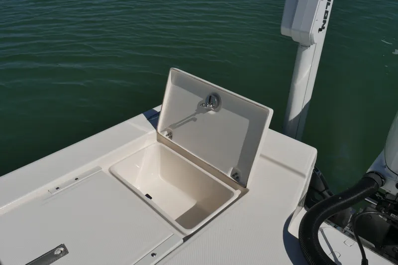 Slide: The Image of 2023 Sea Born FX24 Bay boat with open storage compartment on deck. - 28