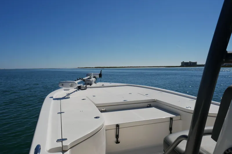 Slide: The Image of 2023 Sea Born FX24 Bay boat on calm water under clear blue sky. - 6
