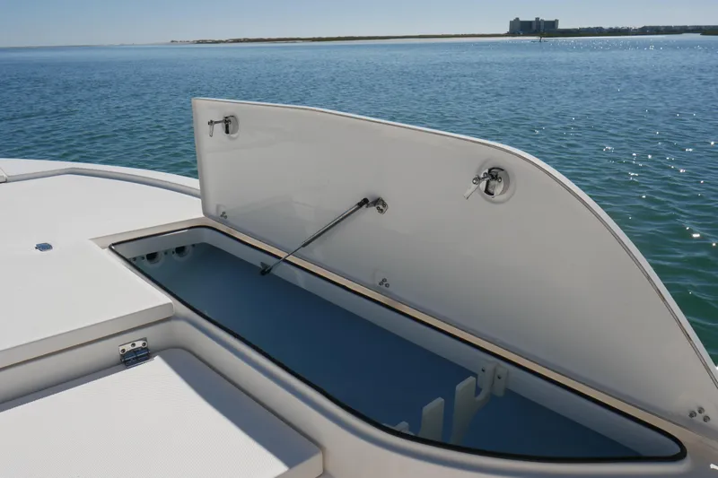 Slide: The Image of 2023 Sea Born FX24 Bay boat with open storage compartment on calm water. - 9