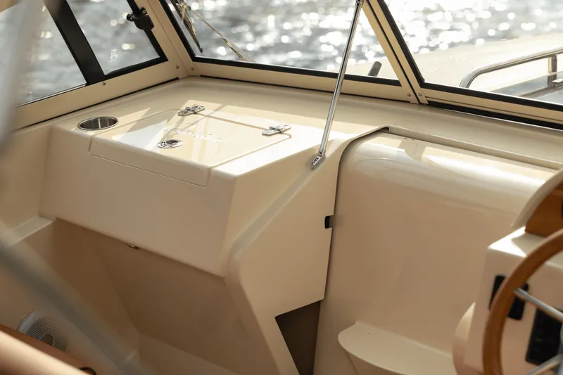 Slide: The Image of 2026 Rossiter 23 boat interior with beige dashboard and steering wheel. - 5