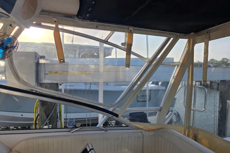 Slide: The Image of Interior view of a 2004 Grady-White Express 330 boat at a marina. - 16