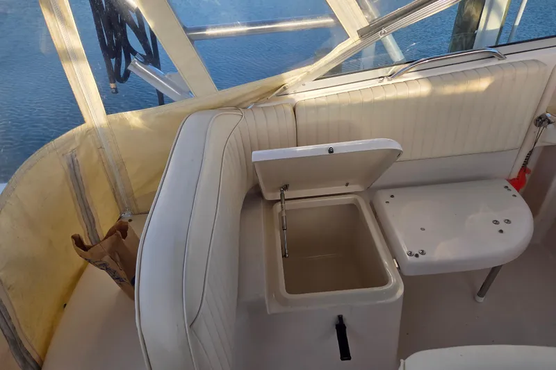 Slide: The Image of 2004 Grady-White Express 330 boat interior with open storage compartment and seating. - 29