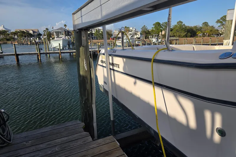 Slide: The Image of 2004 Grady-White Express 330 boat docked at a marina, sunny day. - 3