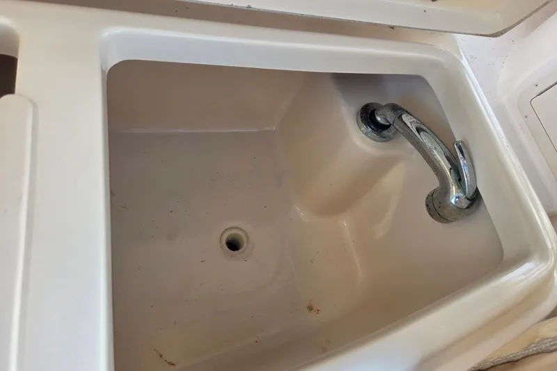 Slide: The Image of 2004 Grady-White Express 330 boat sink with chrome faucet. - 30