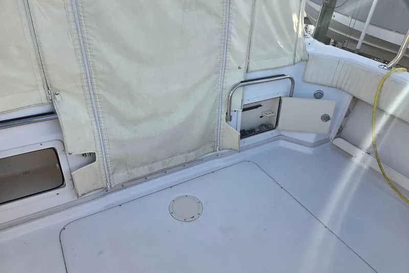 Slide: The Image of 2004 Grady-White Express 330 boat deck with storage compartments and protective cover. - 34