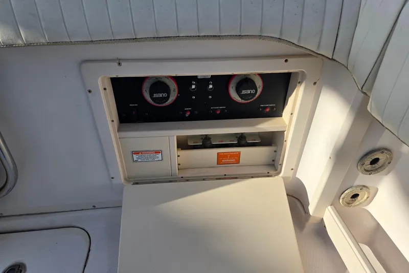 Slide: The Image of Control panel on a 2004 Grady-White Express 330 boat, featuring gauges and switches. - 35