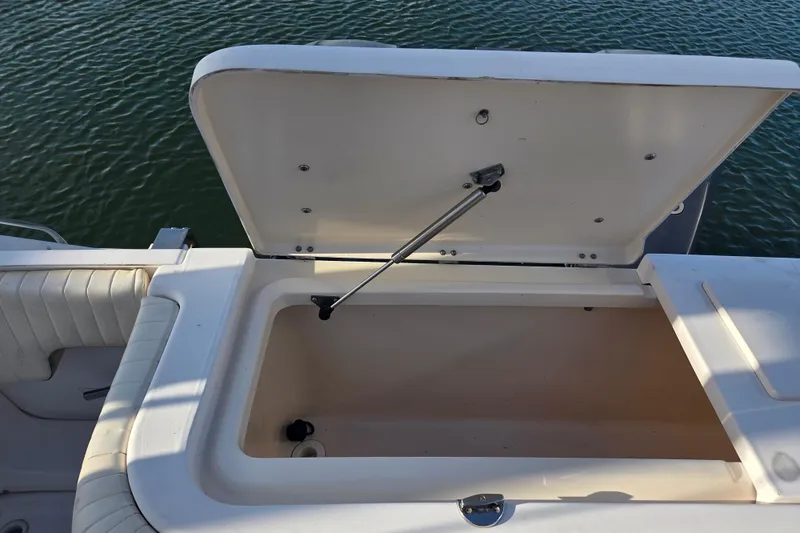 Slide: The Image of Open storage compartment on 2004 Grady-White Express 330 boat, near water. - 39