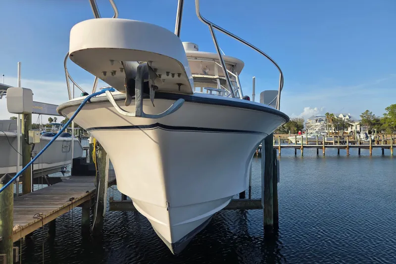 Slide: The Image of 2004 Grady-White Express 330 boat docked at marina, front view. - 4