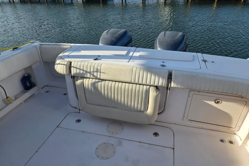 Slide: The Image of 2004 Grady-White Express 330 boat deck with seating and twin engines. - 40