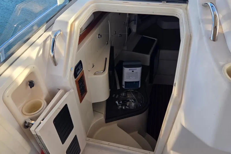 Slide: The Image of 2004 Grady-White Express 330 cabin interior with storage and equipment. - 46