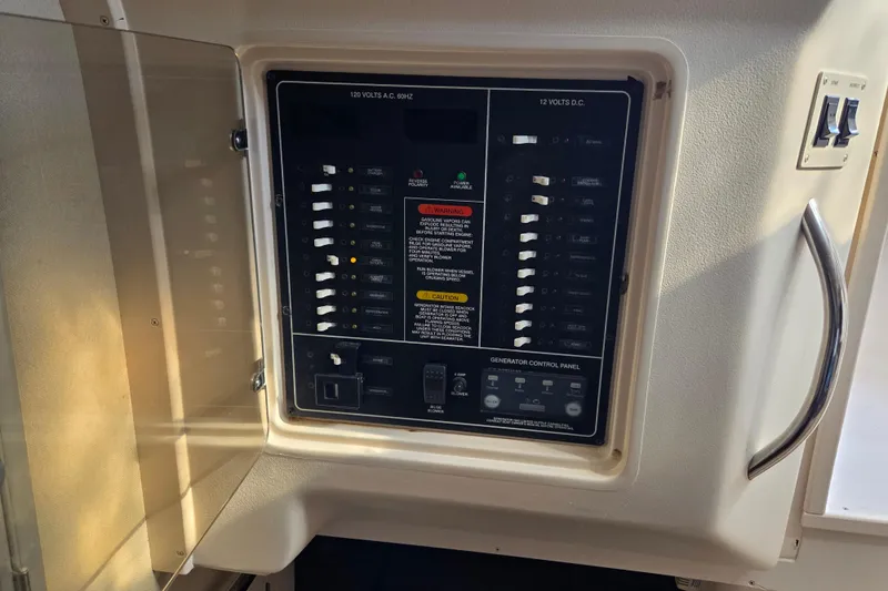 Slide: The Image of Electrical control panel on a 2004 Grady-White Express 330 boat. - 48