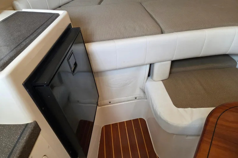 Slide: The Image of 2004 Grady-White Express 330 cabin interior with seating and compact refrigerator. - 58