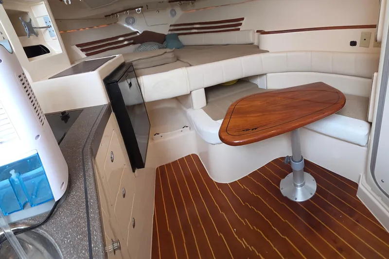 Slide: The Image of Interior of 2004 Grady-White Express 330 boat with seating and wooden table. - 61