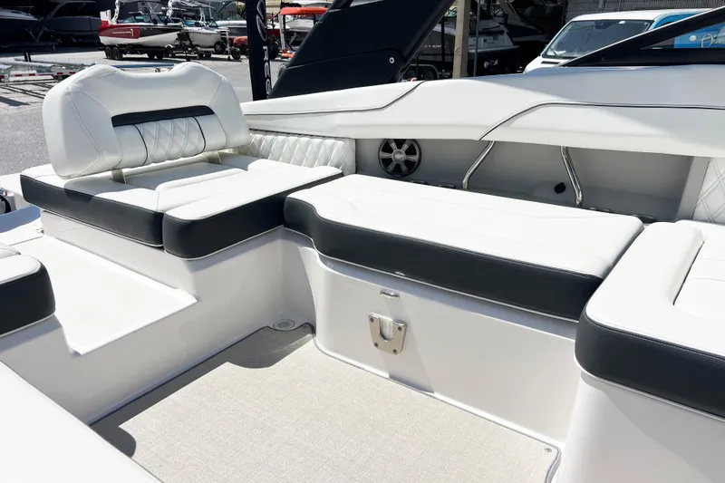 Slide: The Image of Luxurious seating area on 2022 Regal LX2 boat, featuring elegant white and black upholstery. - 7