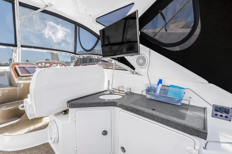 Slide: The Image of Interior of 2007 Regal Commodore 3760 IB yacht with helm, sink, and mounted TV. - 19