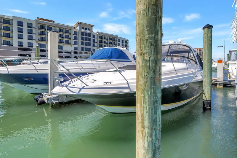 Slide: The Image of 2007 Regal Commodore 3760 IB yacht docked at marina with waterfront buildings. - 2
