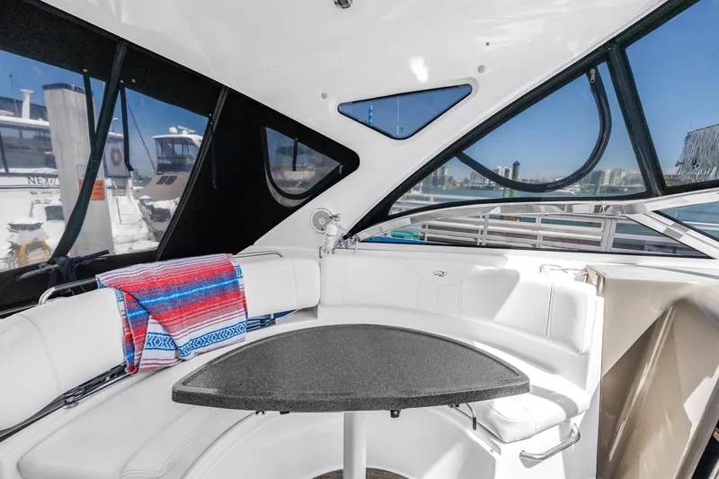 Slide: The Image of Interior of 2007 Regal Commodore 3760 IB yacht with white seating and colorful towel. - 24