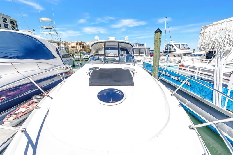 Slide: The Image of 2007 Regal Commodore 3760 IB yacht docked at marina under clear blue sky. - 26