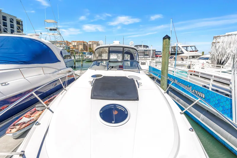 Slide: The Image of 2007 Regal Commodore 3760 IB yacht docked at marina under clear blue sky. - 27
