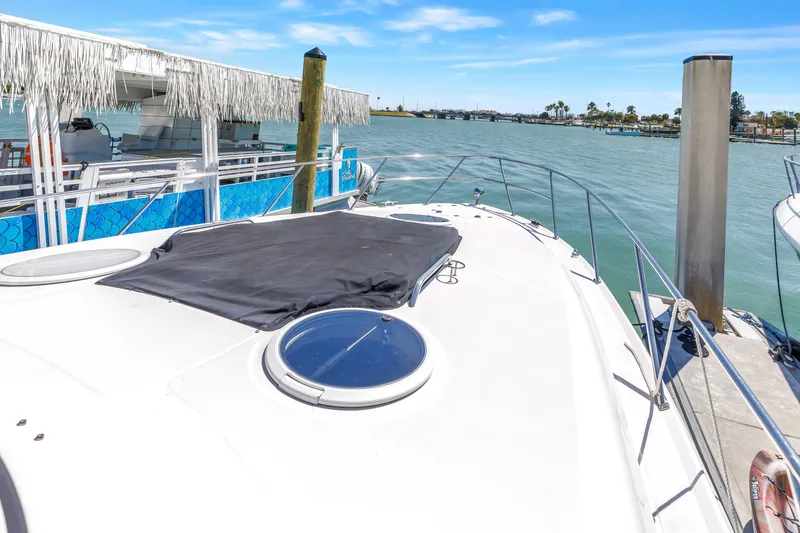 Slide: The Image of 2007 Regal Commodore 3760 IB yacht docked by waterfront under clear blue sky. - 28