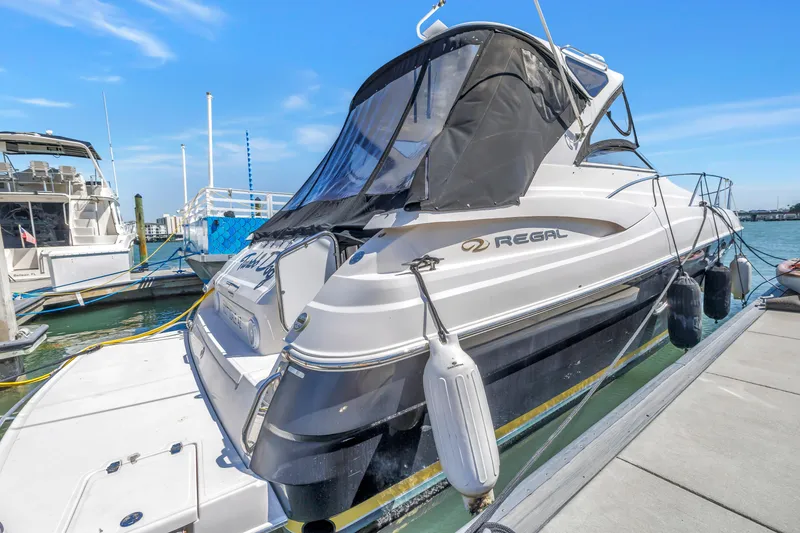 Slide: The Image of 2007 Regal Commodore 3760 IB yacht docked at marina under clear blue sky. - 5